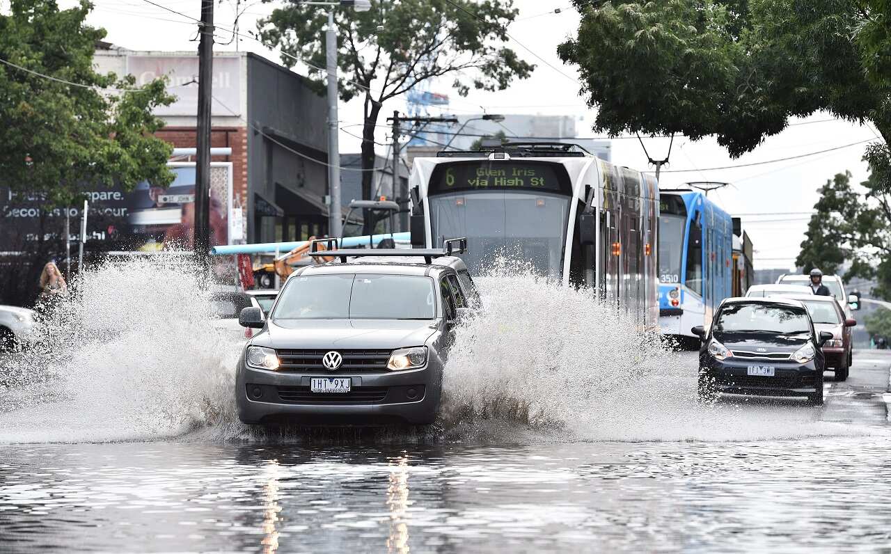 Cars drive through floodwaters in Prahran in Melbourne, Wednesday, Dec. 28, 2016. 