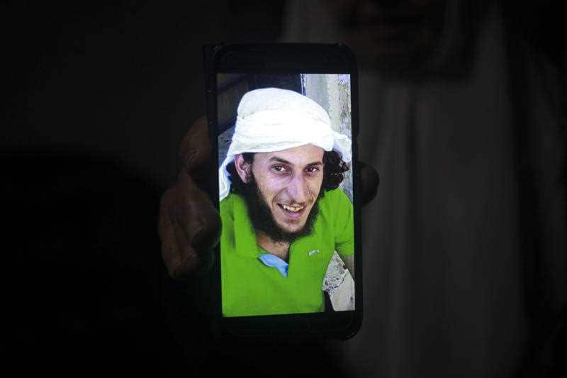 A relative shows a photo of Fadi Kunbar, 28, outside his home in Jerusalem, Sunday, Jan. 8, 2017. 