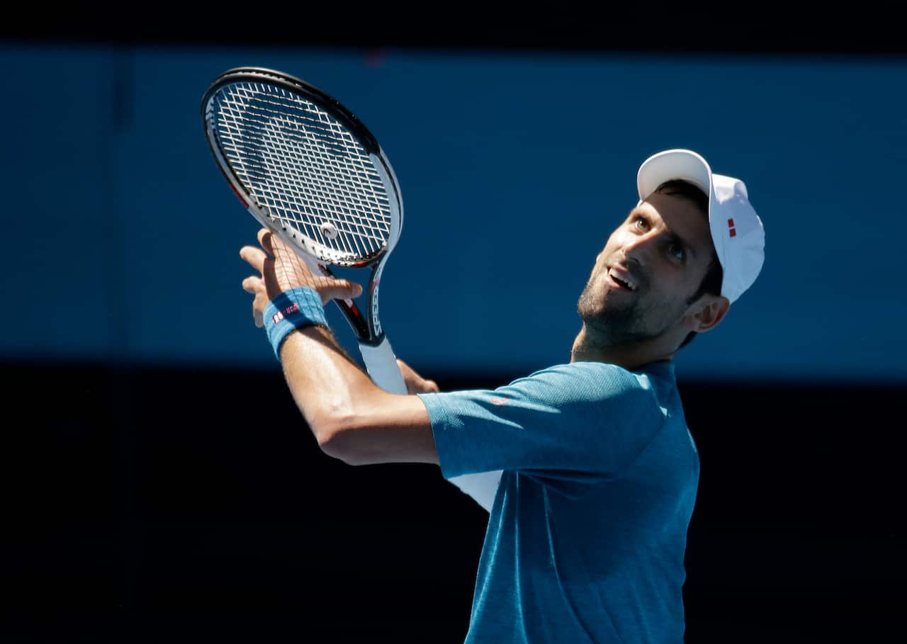 Serbia's Novak Djokovic looks to make a forehand return during a practice session ahead of the Australian Open tennis championships in Melbourne, Australia, Thursday, Jan. 12, 2017. (AP Photo/Mark Baker)