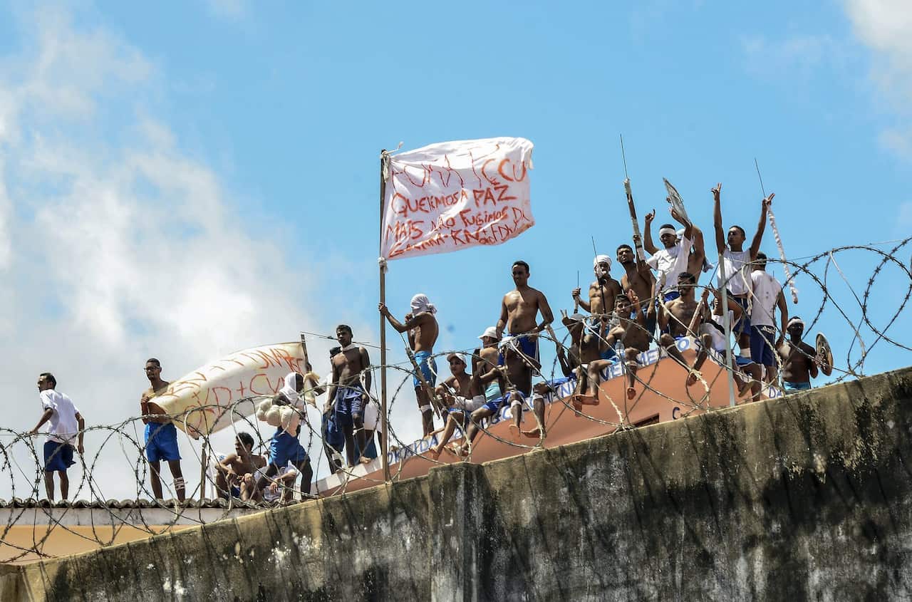 A group of inmates stand on a roof inside the State Penitentiary of Alcacuz in Nisia Floresta near Natal, Rio Grande do Norte, Brazil in January 2017. 