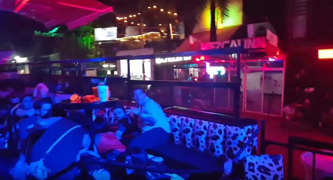 A video grab shows people protecting themselves during a shooting in Playa del Carmen, Mexico, early 16 January 2017. 