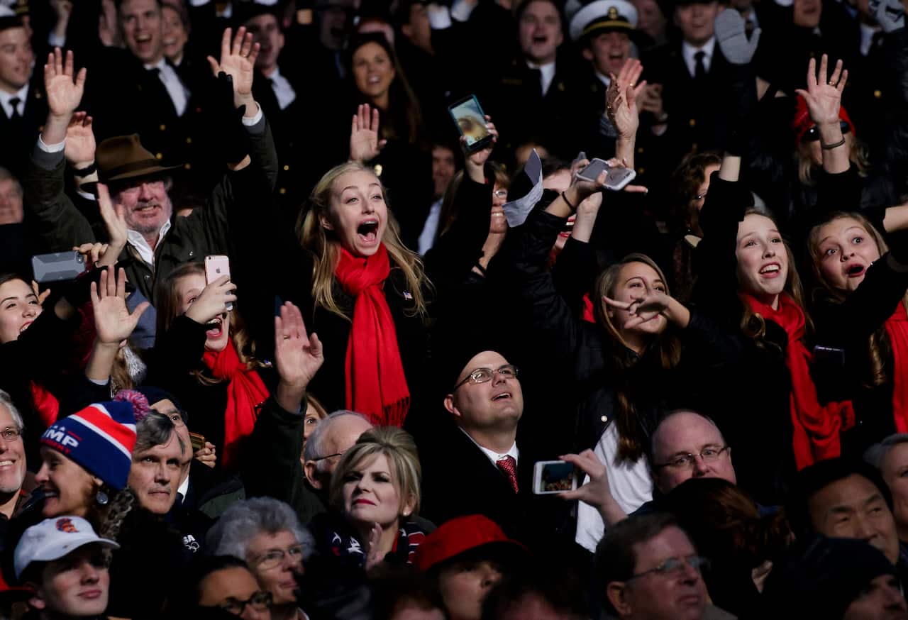 Audience members cheer during the 'Make America Great Again! Welcome Celebration'