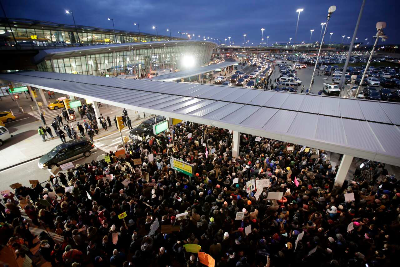 People gather for a protest at Terminal 4 of John F Kennedy Airport, after people arriving from Muslim countries were detained at border control.