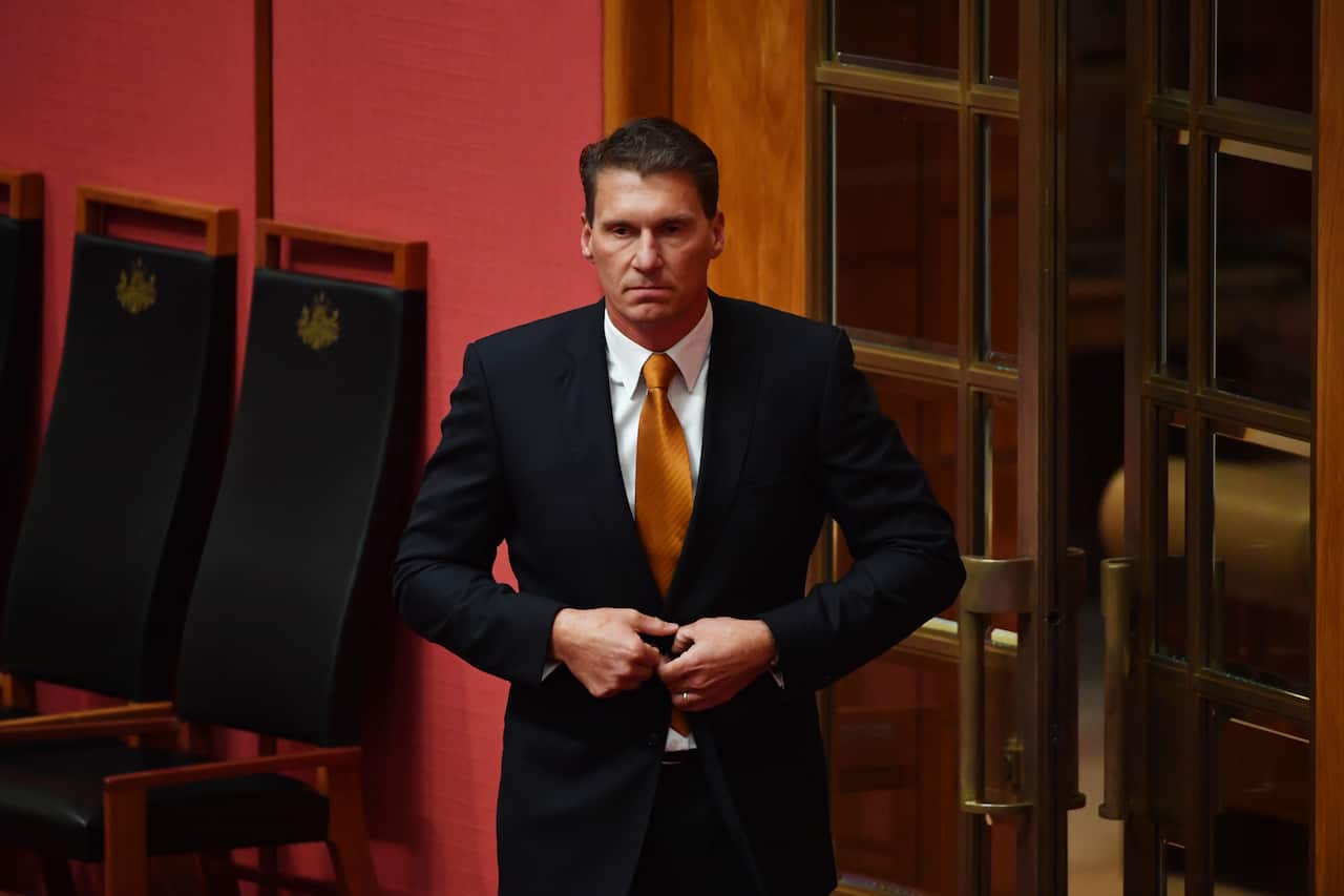 Australian Senator Cory Bernardi leaves after announcing  his defection from the Liberal Party at Parliament House in Canberra.