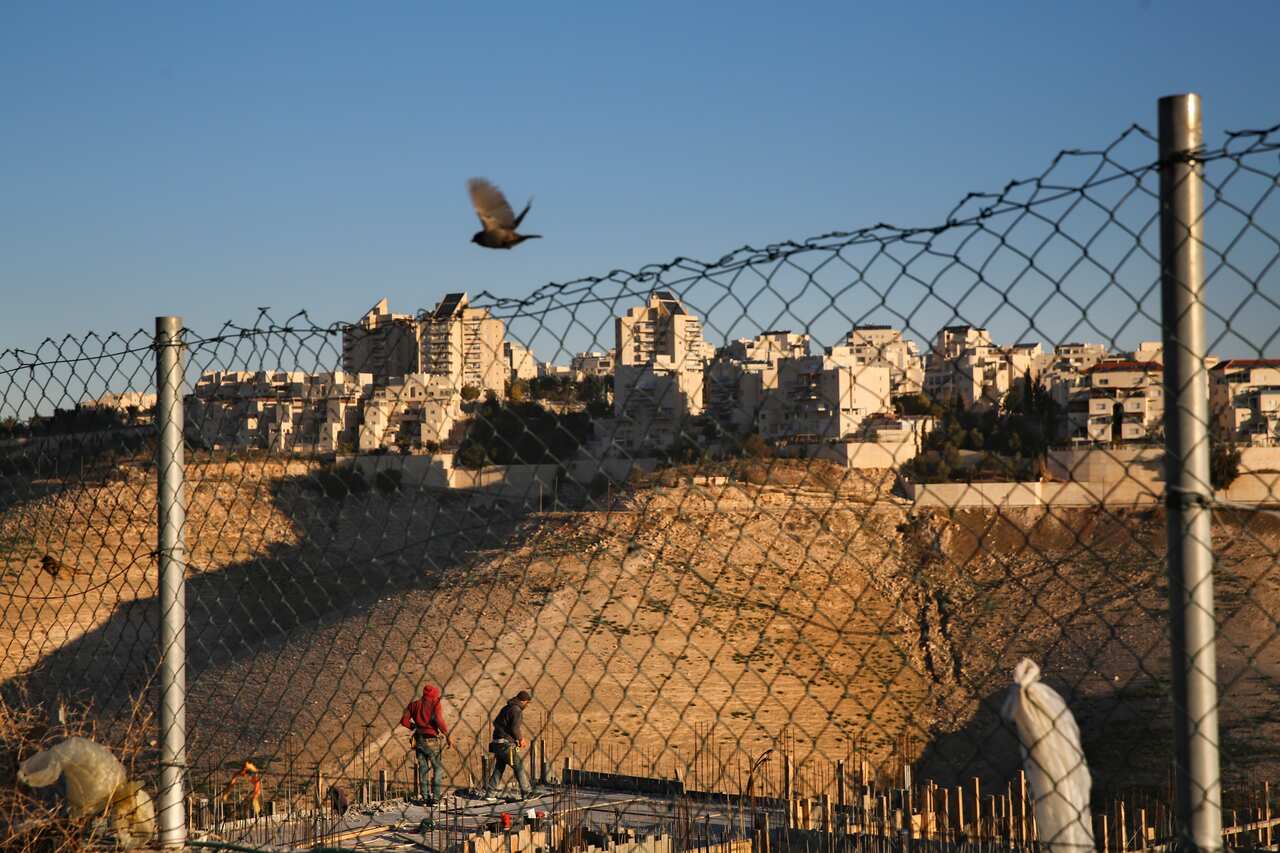 Palestinian labourers work at a construction site in a new housing project in the Israeli settlement of Maale Adumim, near Jerusalem in 2017