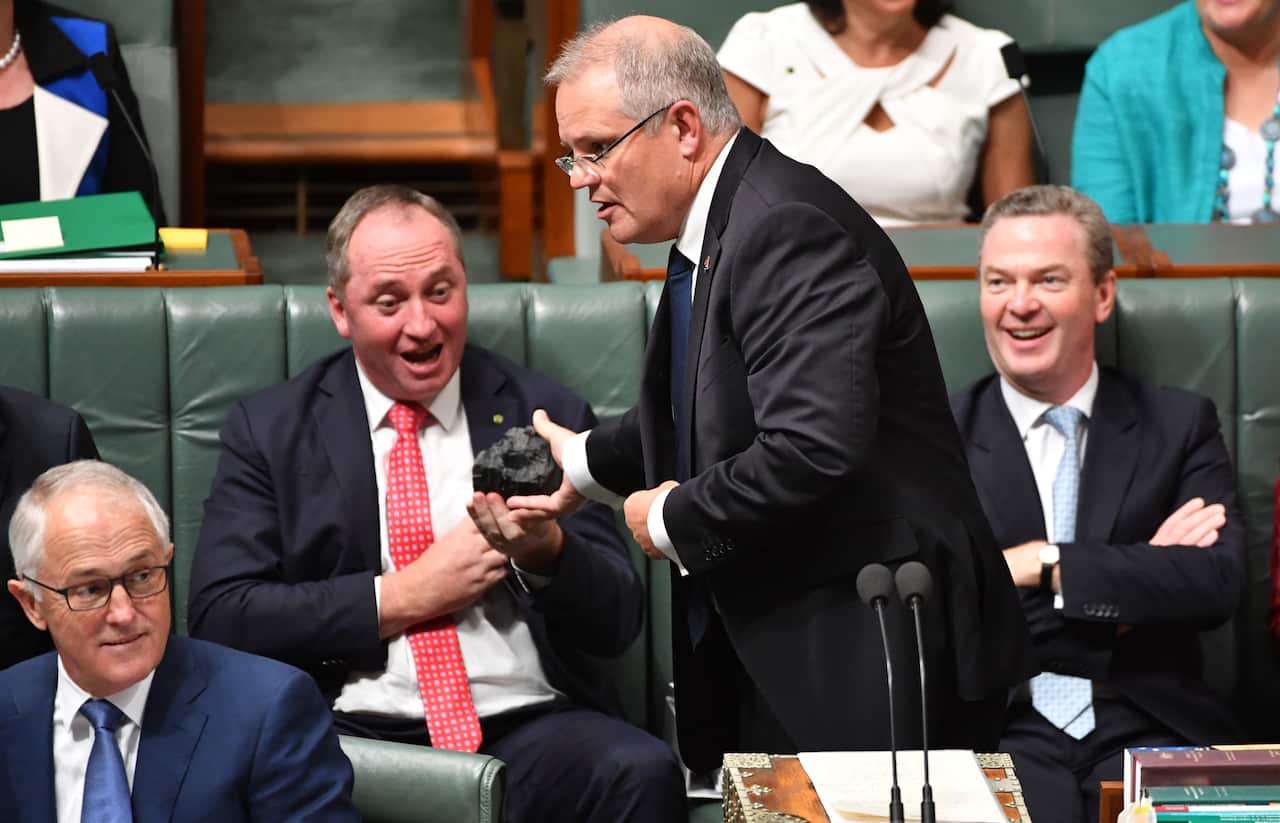 Then-treasurer Scott Morrison presents coal to Parliament. Labor is now trying to balance its messaging on mining and climate change.