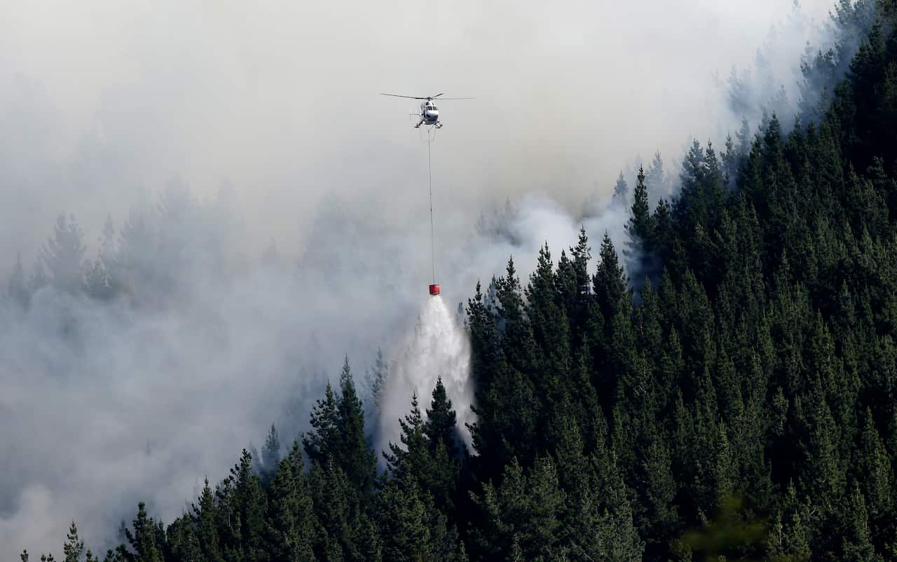 Up to 15 helicopters, and over a 100 firefighters have been battling two massive wildfires that have burnt over 700ha since erupting on Monday evening.