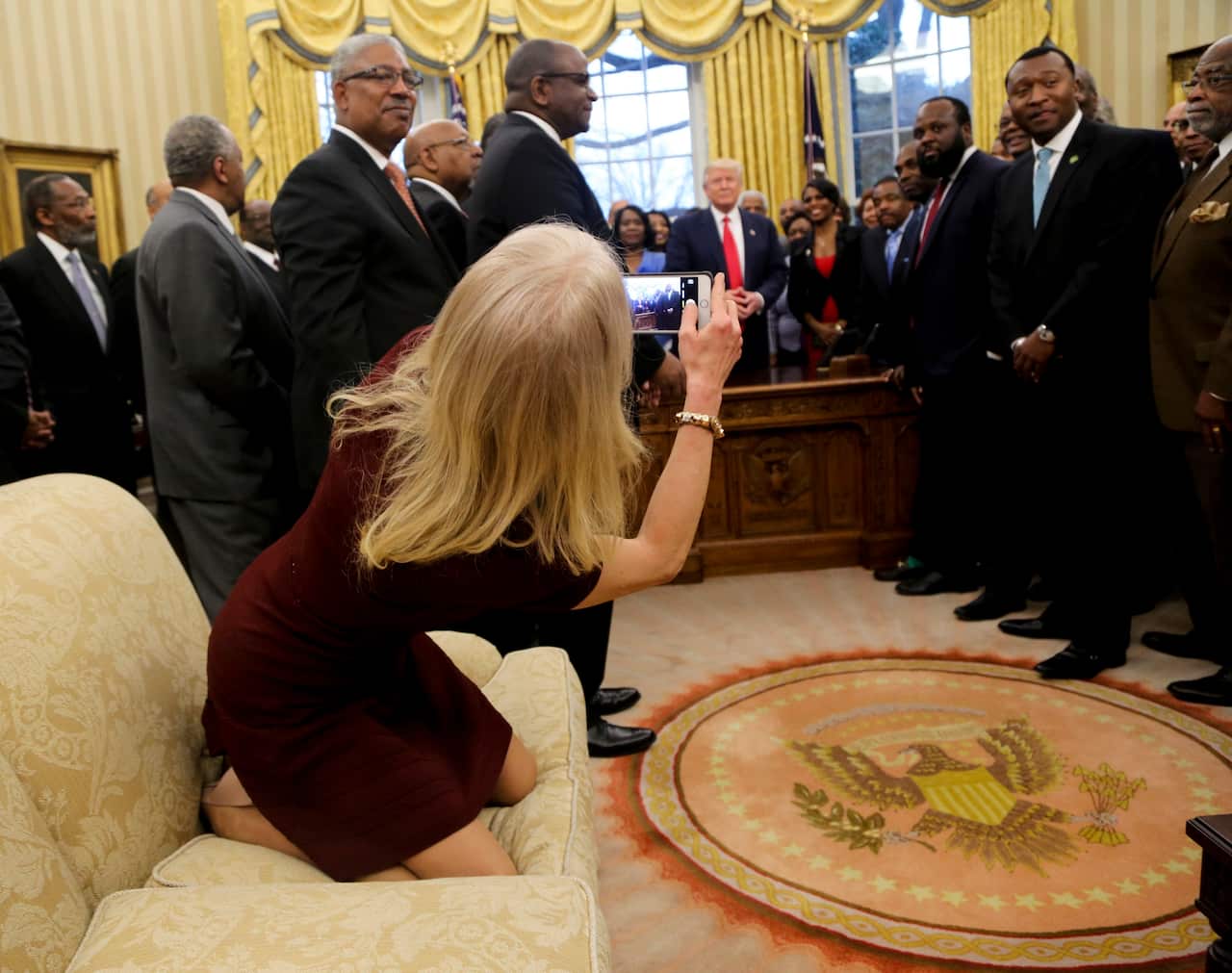 Counselor to the President Kellyanne Conway takes a photo as Trump meets leaders of historically black universities and colleges.