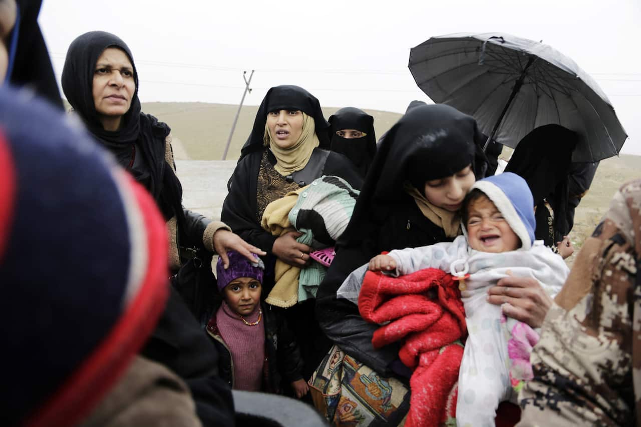 Families flee clashes between Iraqi forces and Islamic State group militants in western Mosul.