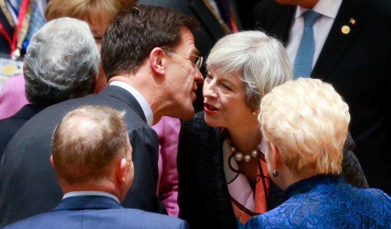 Dutch PM Mark Rutte, left, greets British Prime Minister Theresa May during a round table meeting at an EU summit in Brussels on Thursday, March 9, 2017.