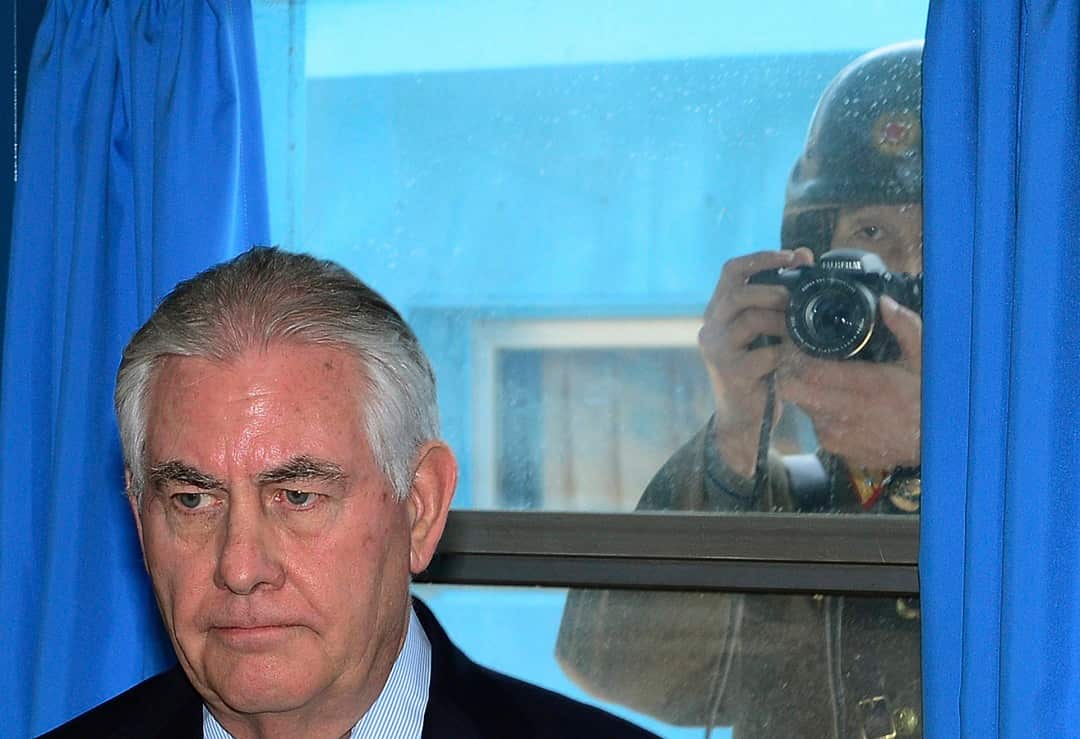 A North Korean soldier photographs US Secretary of State Rex Tillerson at Panmunjom.