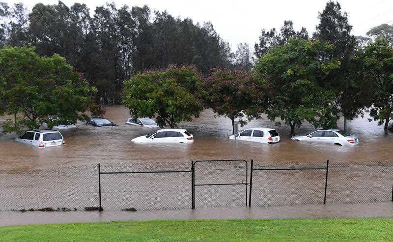 Cars sit in flood waters outside the Robina Hospital on the Gold Coast