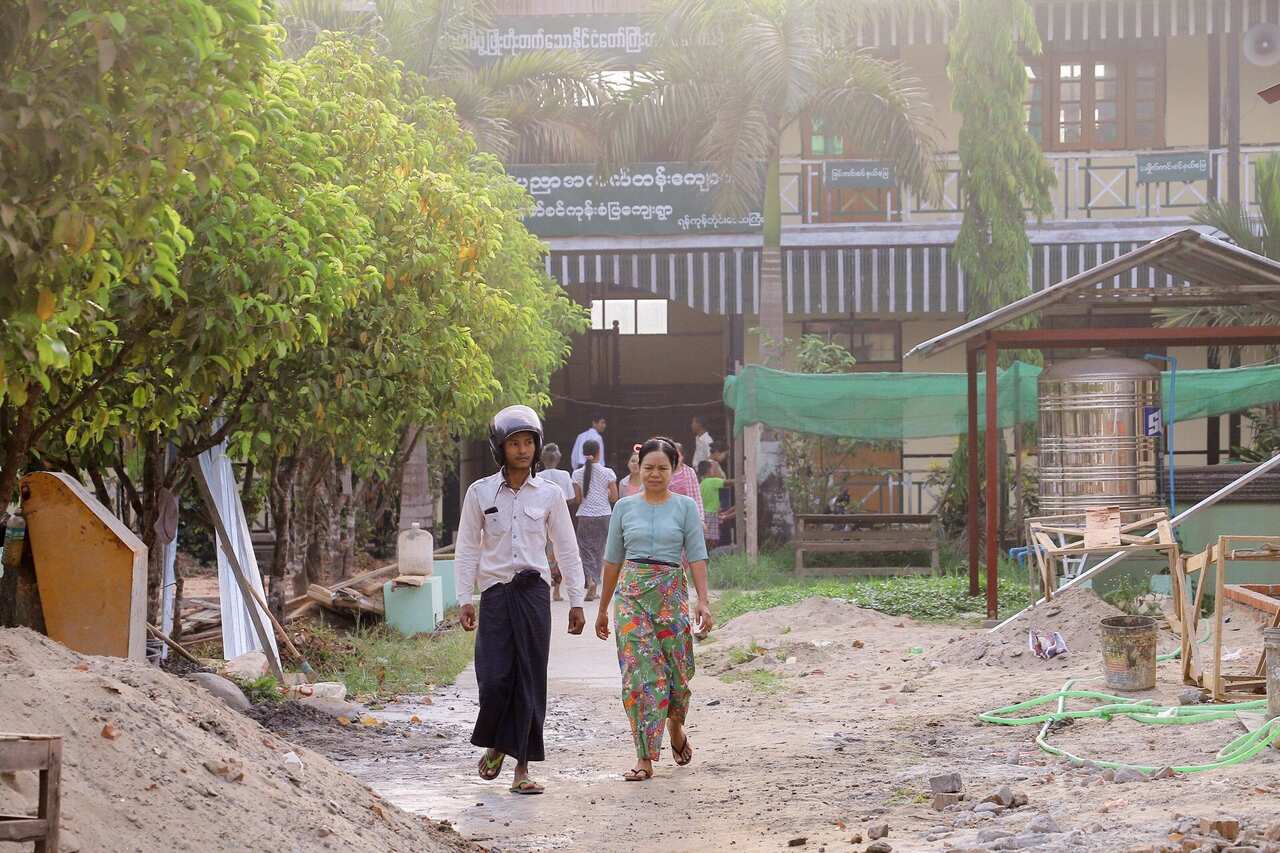 Voters leave a polling station after casting their votes for by-elections in Kawhmu Township.