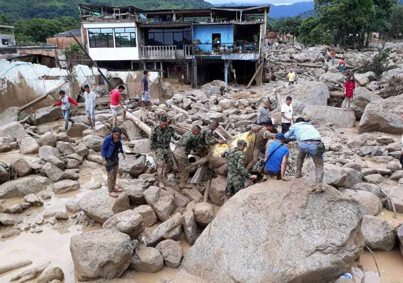 soldiers carry a victim, in Mocoa, Colombia