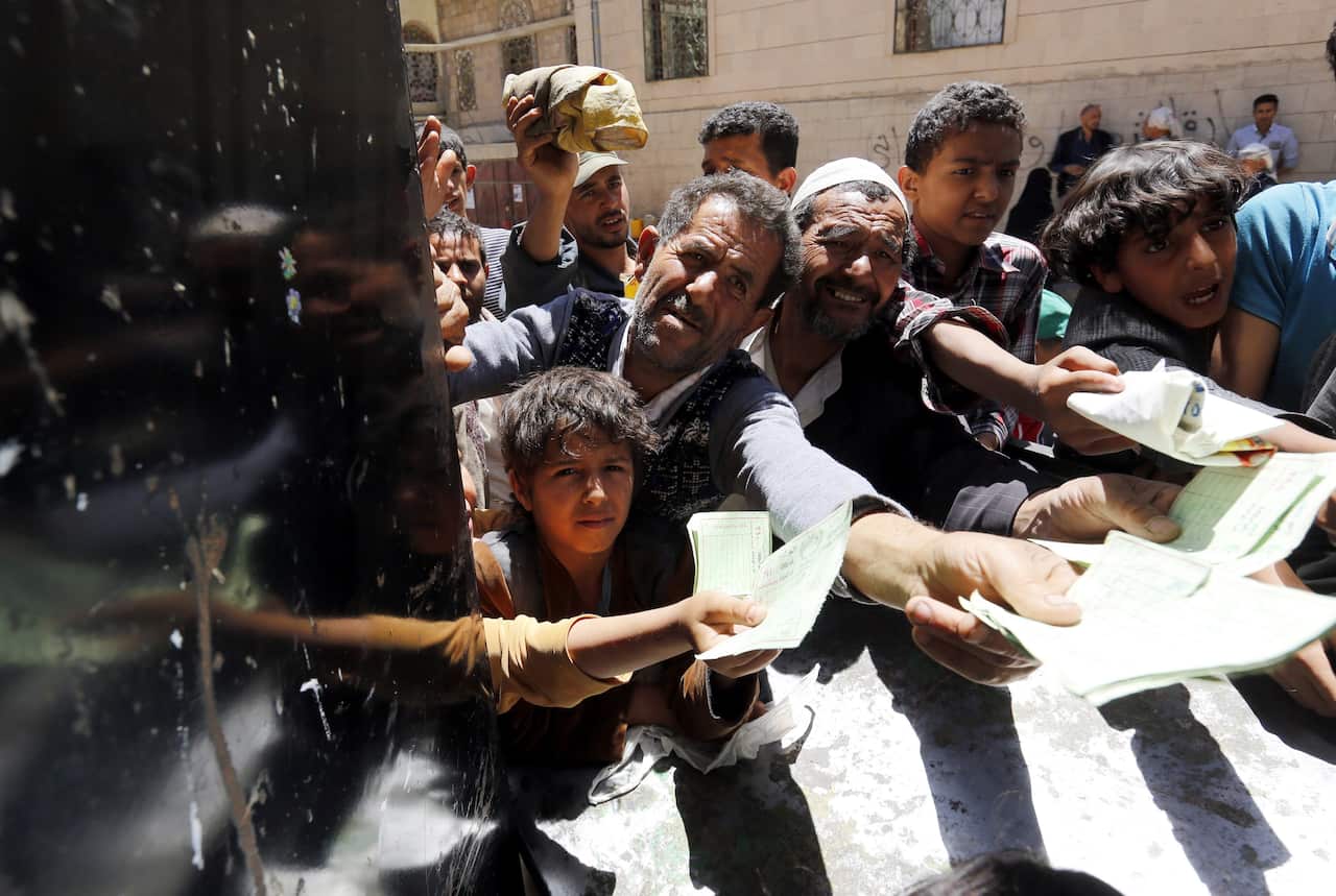 Conflict-affected Yemenis receive local charity-provided food rations in Sana'a, Yemen, 13 April 2017.