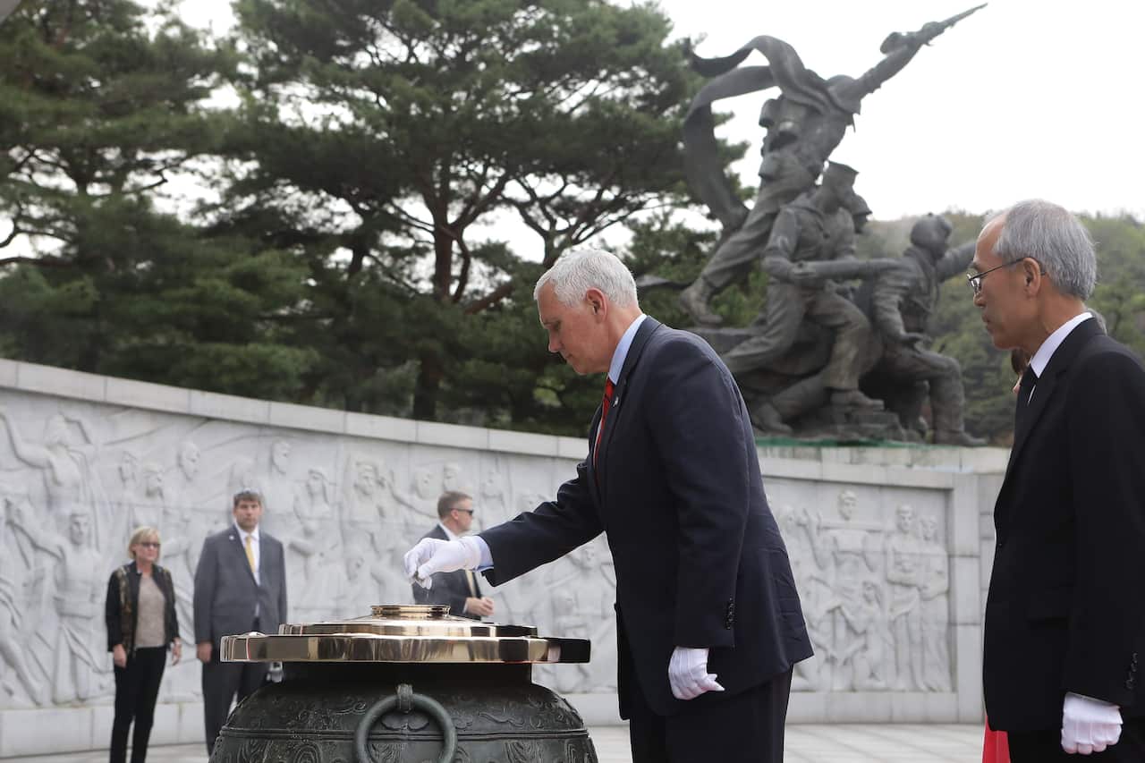 US Vice President Mike Pence burns incense at the Seoul National Cemetery, in South Korea.