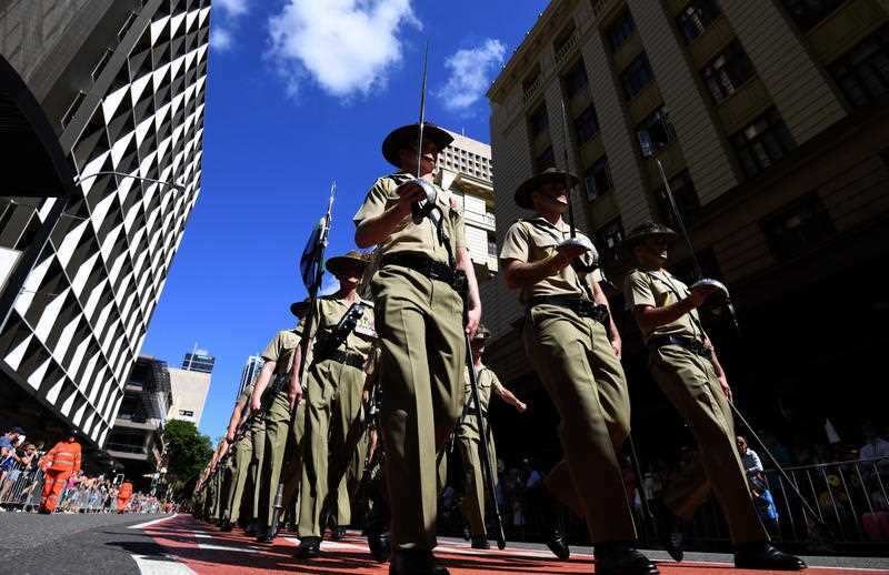 Defence forces veterans and active servicemen and women take part in an ANZAC Day march through central Brisbane