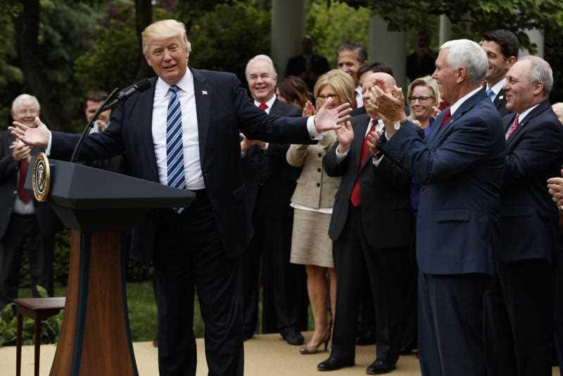 President Donald Trump, accompanied by GOP House members, speaks in the Rose Garden of the White House in Washington, Thursday, May 4, 2017