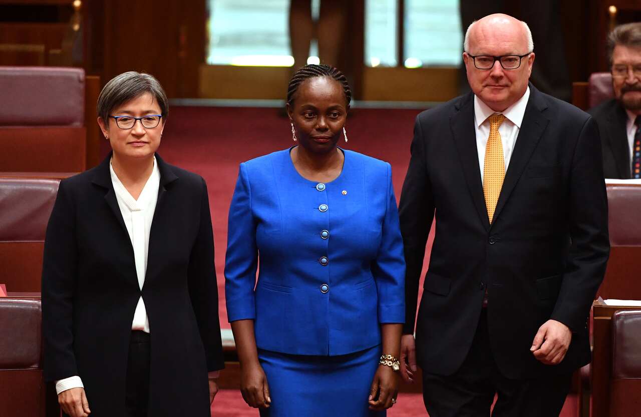 Lucy Gichuhi, centre, arrives for her swearing in ceremony at Parliament House in Canberra on 9 May 2017.