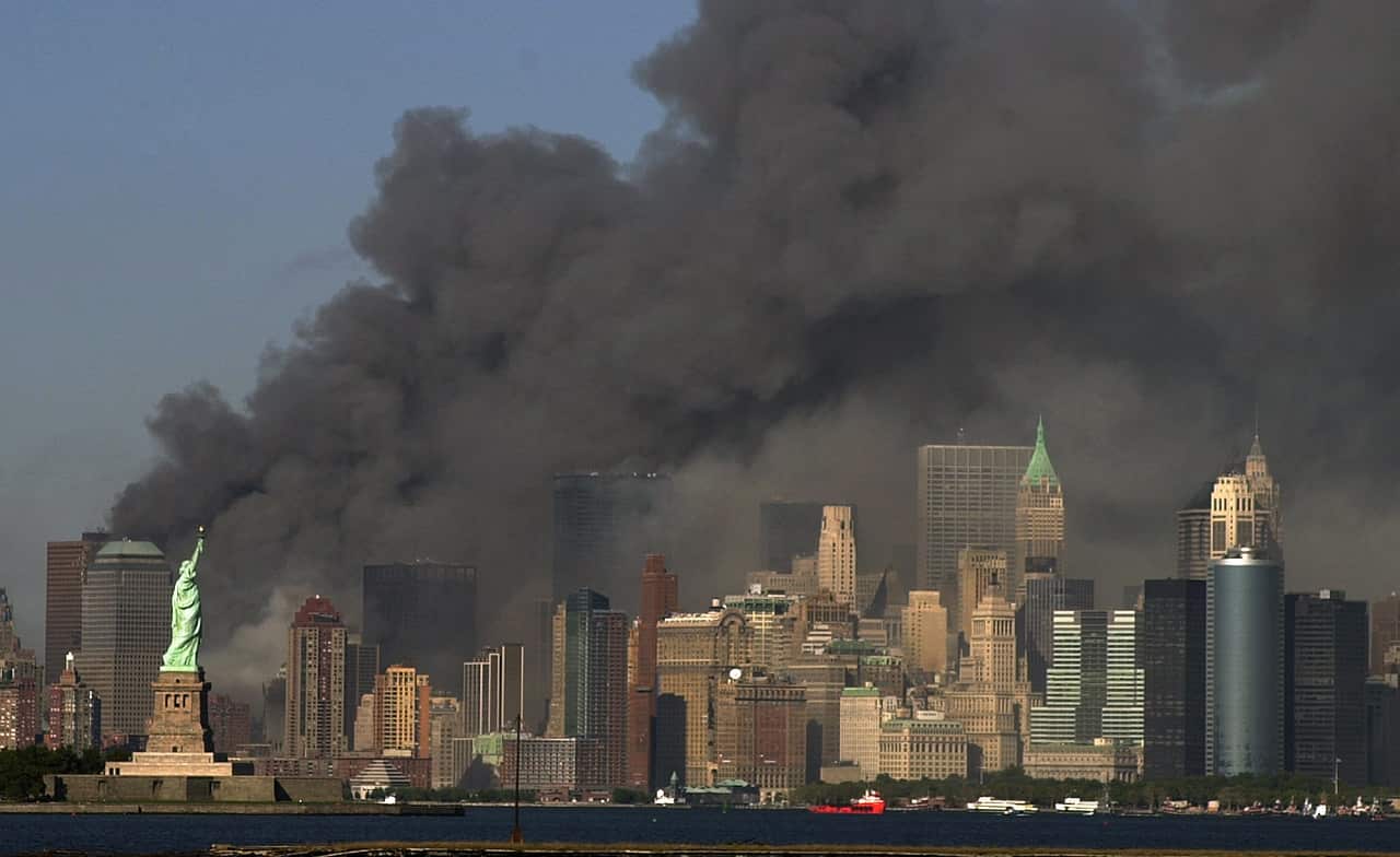 Fire and smoke billows from the north tower of New York's World Trade Center after terrorists crashed two hijacked airliners into the World Trade Center and br