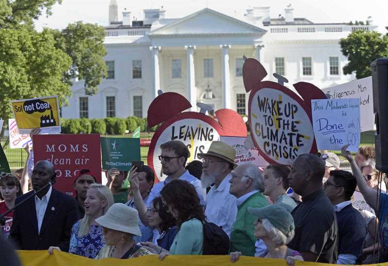 Protesters gather outside the White House in Washington, Thursday, June 1, 2017, to protest President Donald Trump's decision to withdraw the Unites States from the Paris climate change accord.