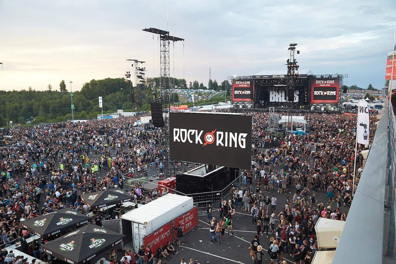 Visitors leave the music festival Rock am Ring outside the western town of Nuerburg, Germany, Friday, June 2, 2017. German authorities have shut down a popular rock music festival because of a possible terrorist threat. (Thomas Frey/Dpa via AP)