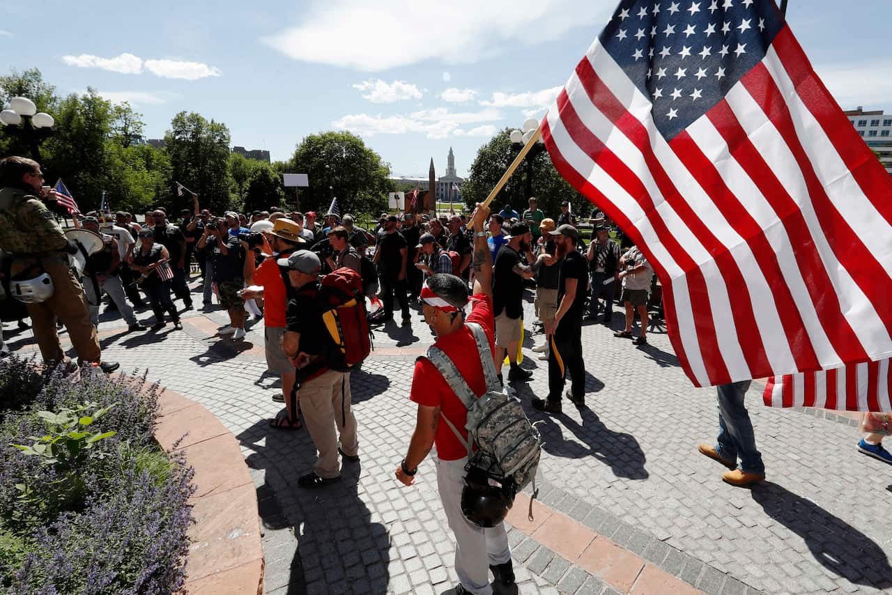 Protesters against Muslims wave American flags during an ACT for America rally. 