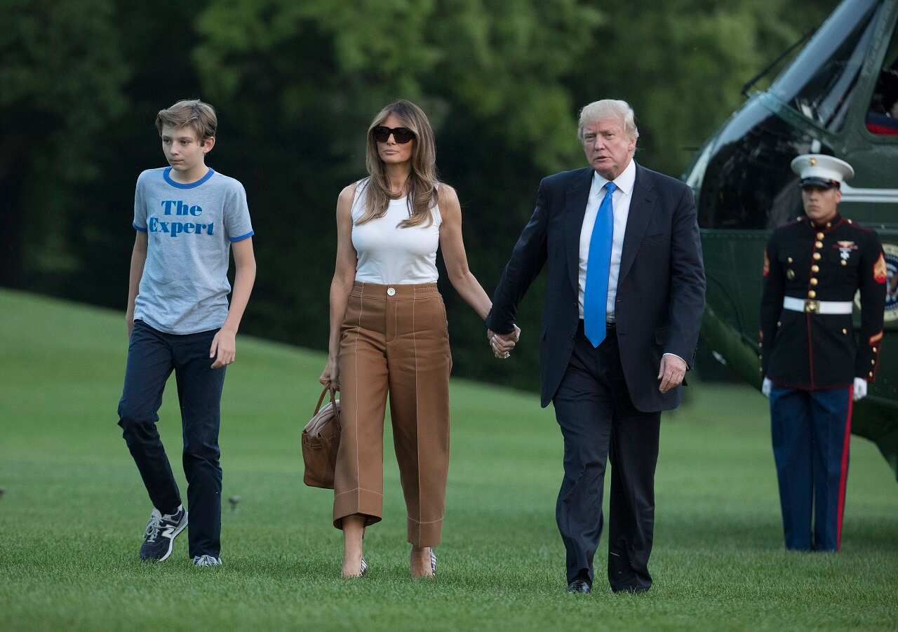 President Donald Trump, first lady Melania Trump, and their son and Barron Trump walk from Marine One to the White House