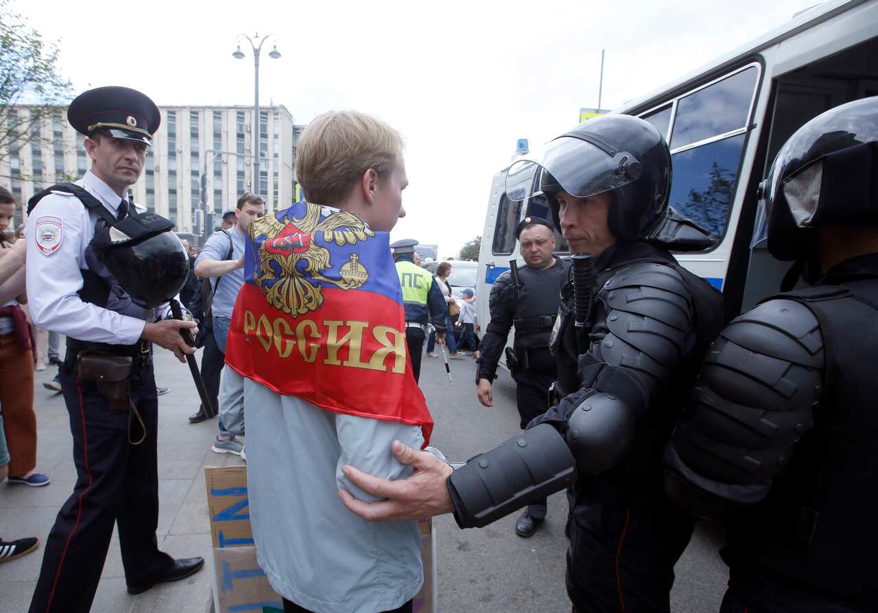 Russian police officers detain a participant of an unauthorized opposition rally in Tverskaya  street in central Moscow, 12 June 2017. 