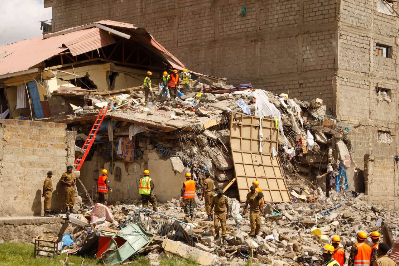 Rescuers work at the site of a building collapse in Nairobi, Kenya Tuesday, June 13, 2017. Nairobi Police Chief Japheth Koome said Tuesday that at least 10 people had been reported missing after the collapse Monday night. (AP Photo/Khalil Senosi)