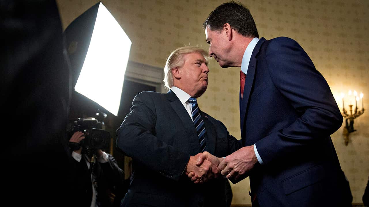 President Donald Trump, left, shakes hands with James Comey, then director of the Federal Bureau of Investigation (FBI).