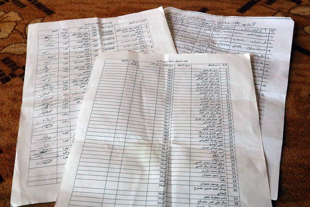 In this May 11 2017 photo, families showed lists of detainees held in Mukalla's Riyan prison which is run by the United Arab Emiratis. 