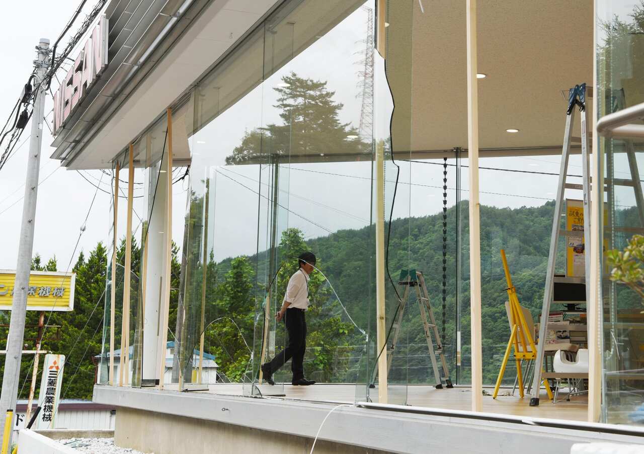 Photo shows damage from the earthquake at a car dealership