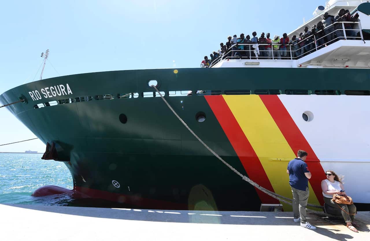 Migrants wait to disembark from the Spanish ship Rio Segurain in the harbour of Salerno, Italy.