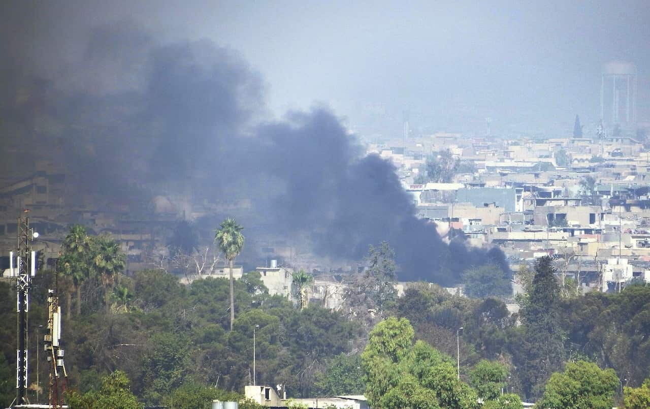 Black smoke is seen around Mosul during fighting between IS and Iraqi forces.