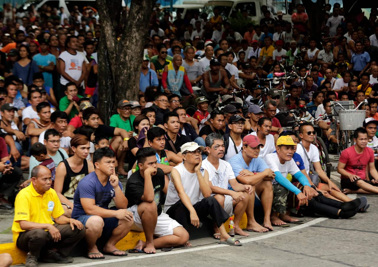 Filipino spectators watch a live broadcast from Brisbane of the boxing match between Manny Pacquiao and Jeff Horn.