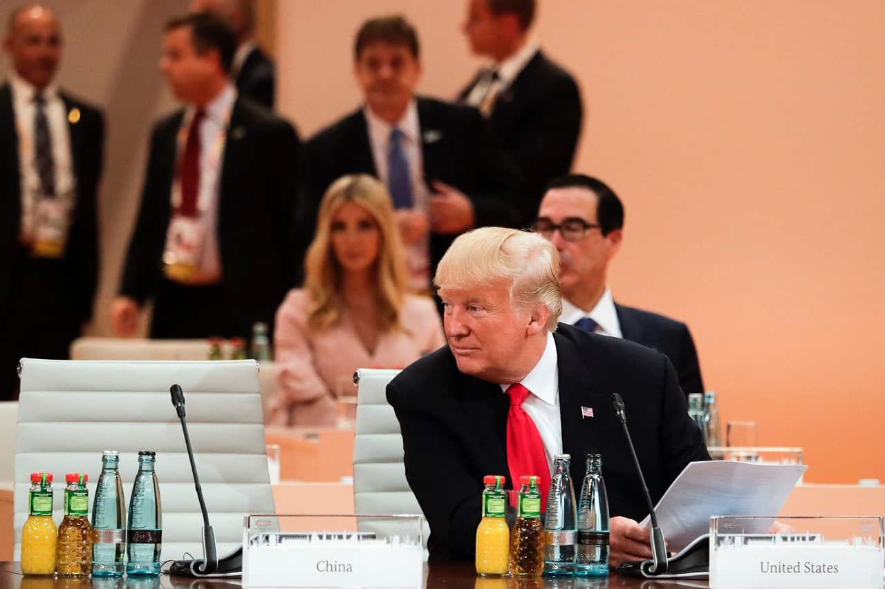 U.S. President Donald Trump sits in front of his delegation with daughter Ivanka Trump, during working session at the G20 Summit, Hamburg.