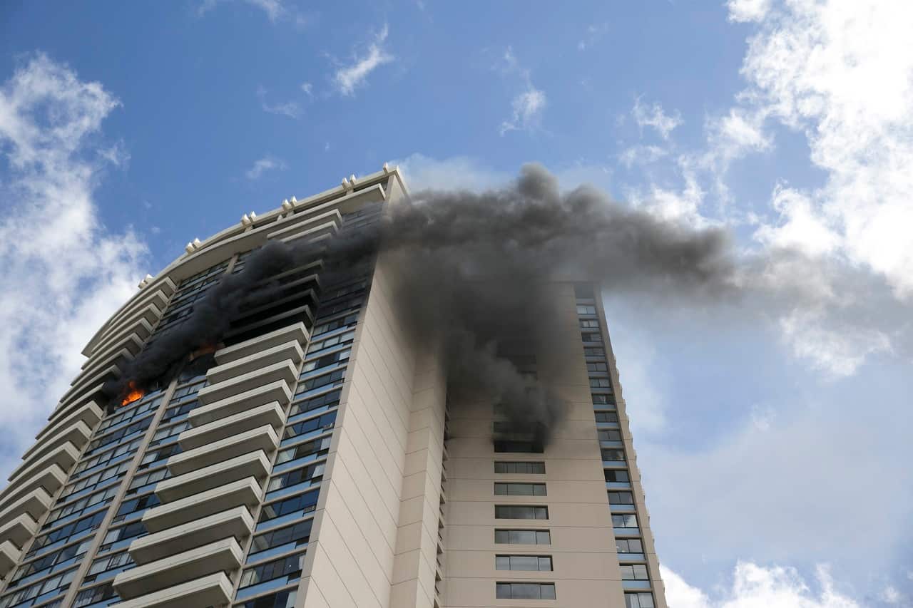 Smoke billows from the upper floors of the Marco Polo apartment complex, Friday, July 14, 2017, in Honolulu. 