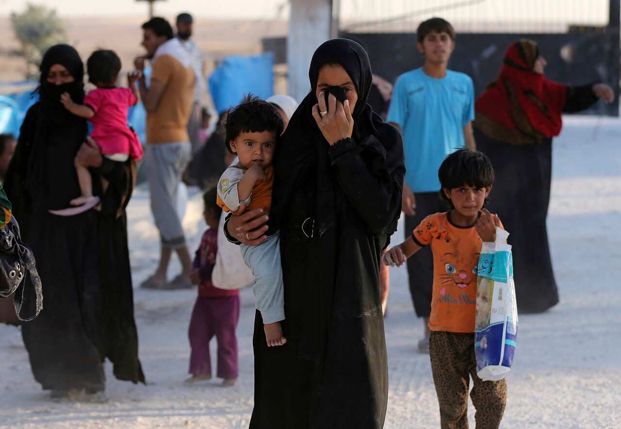 A Syrian displaced family who fled from Raqqa city, arrive at a refugee camp, in Ain Issa town, northeast Syria, Monday, July 24, 2017. 