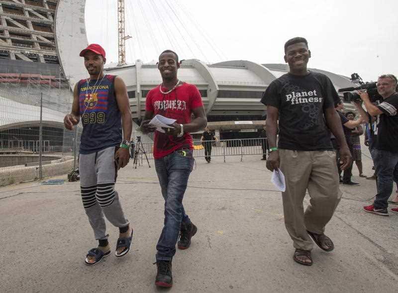 Asylum seekers from Haiti leave Olympic Stadium in Montreal, Canada.
