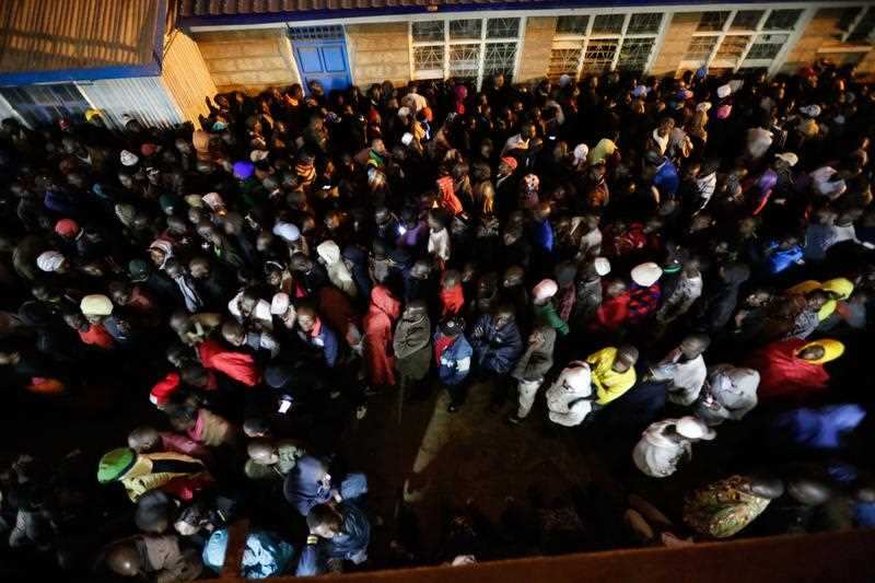 Kenyan voters queue as they wait to cast their votes at a polling station in the Kibera slum in Kenya.