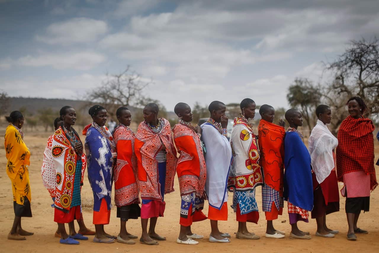 Maasai women wait in line to cast their votes in general elections at a polling station in Iloodokilani in Kajiado County, 100km south of the capital Nairobi.