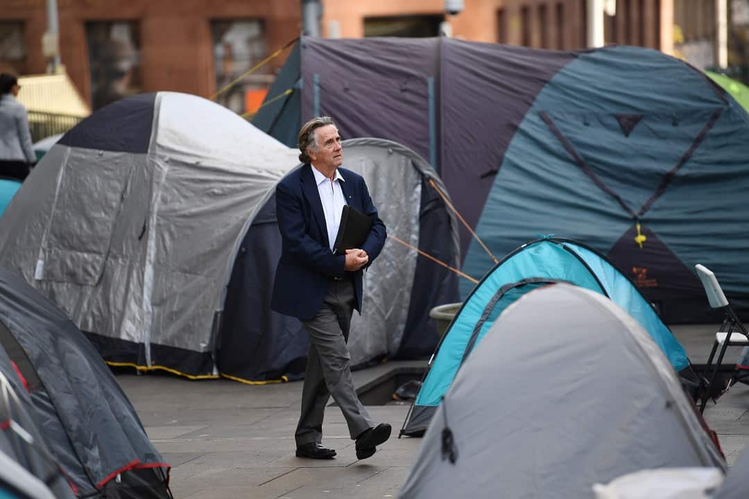 A man walks through tent city in August 2017.