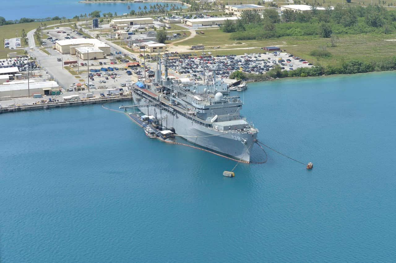 file hows the submarine tender USS Emory S. Land and the Los Angeles-class attack submarine USS Topeka pierside in their home port at Polaris Point, Guam