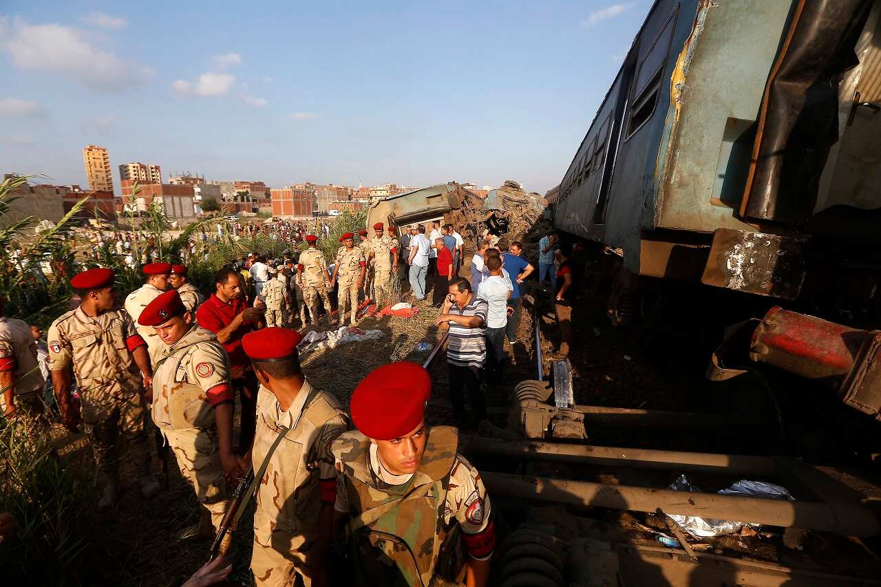 Army attend the scene of a train collision just outside Egypt's Mediterranean port city of Alexandria.