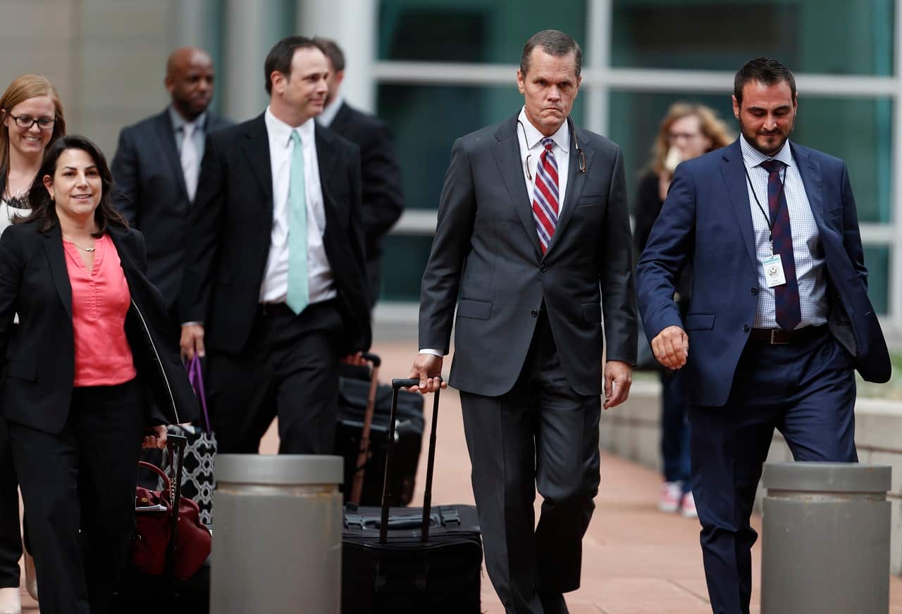 Douglas Baldridge, front center, attorney for pop singer Taylor Swift, leads his legal team out of the federal courthouse.