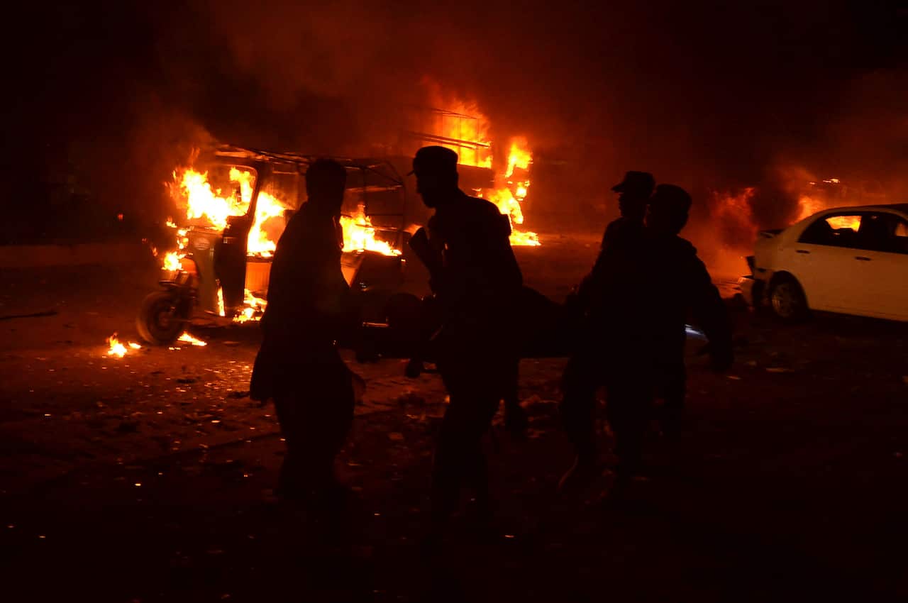 Pakistani volunteers and soldiers carry a blast victim in Quetta, Pakistan.