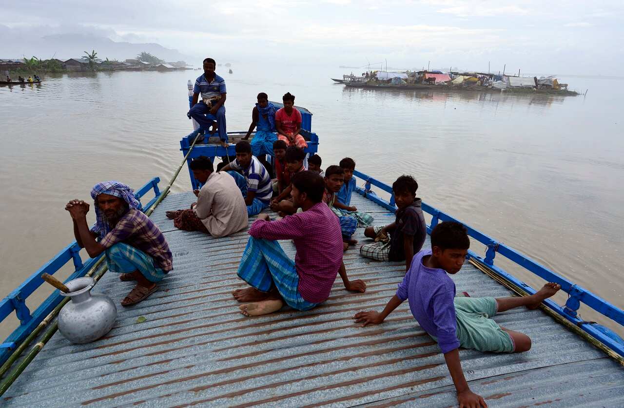 Flood affected villagers leave their village in the flood affected Morigaon district of Assam state, India 13 August 2017.