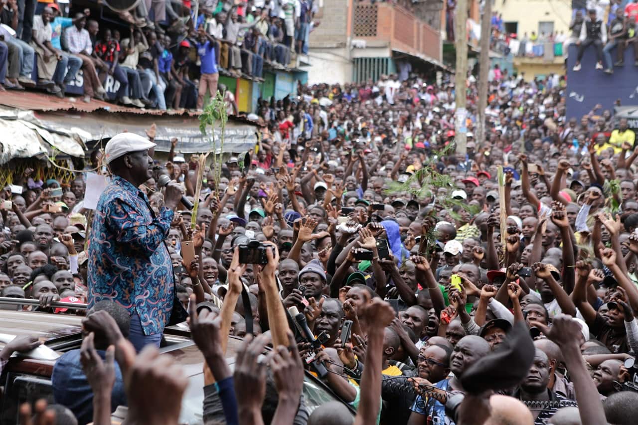 Kenyan opposition leader Raila Odinga (C) addresses thousands of his supporters after visiting the family of a young girl killed by a stray bullet.