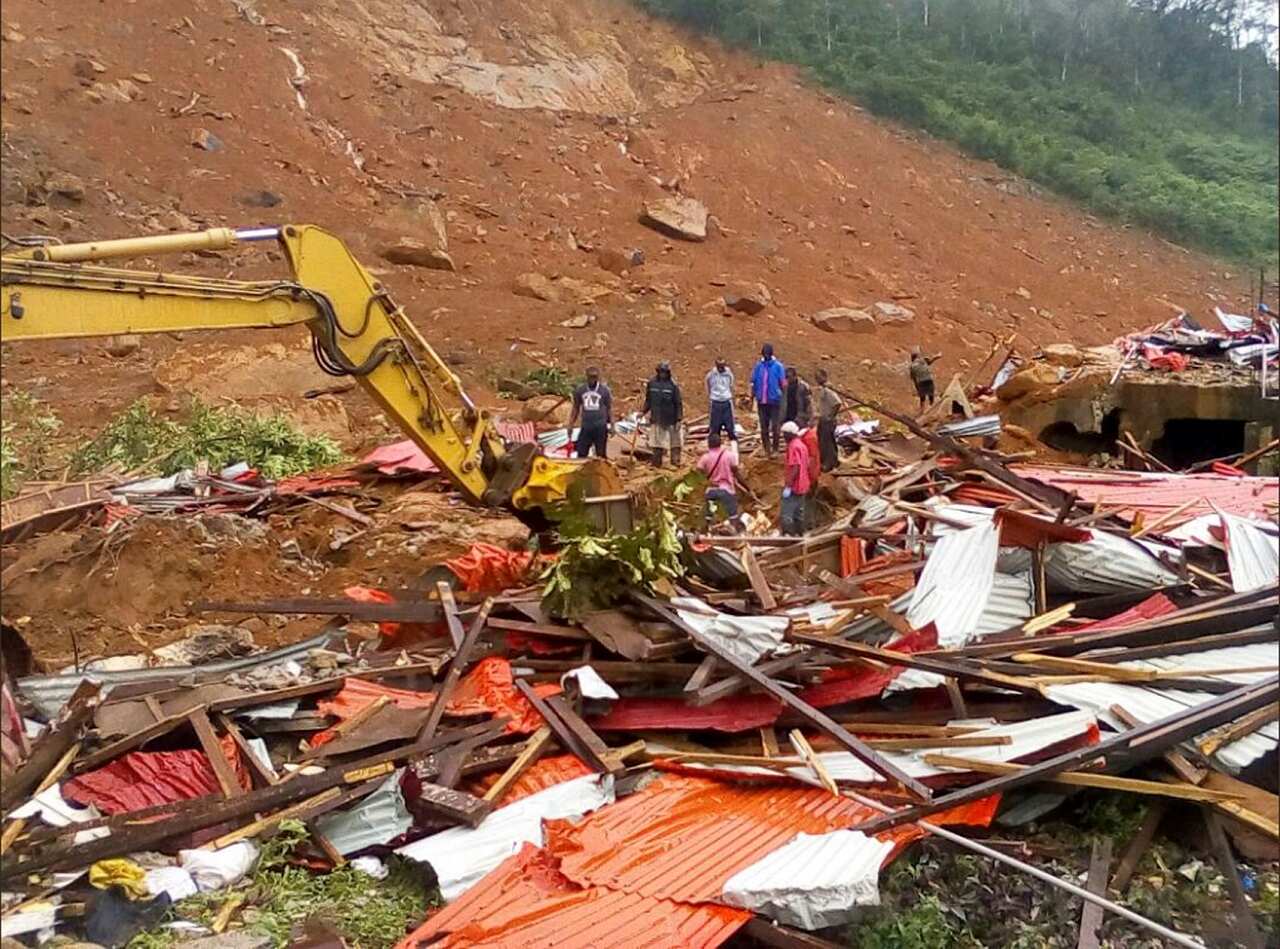People survey the damage after mudslides in Regent, east of Freetown, Sierra Leone.